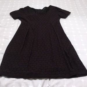 Fully lined black dress with sleeves.